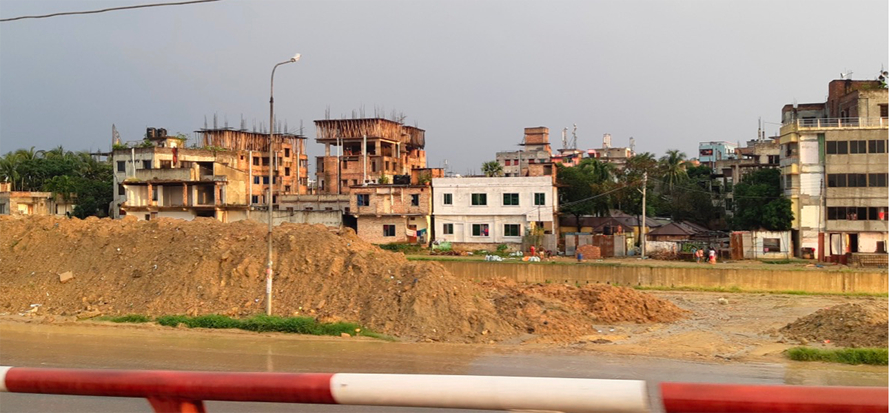 Buildings under construction next to a river in Bangladesh